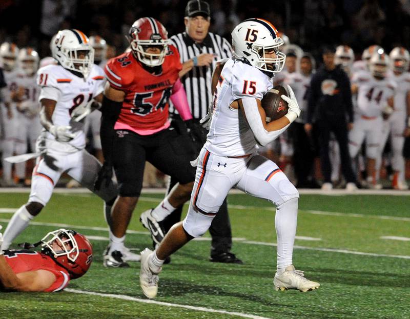 Oswego defender Donavan Williams (15) flies down the field for a pick six interception against Yorkville on Friday, Oct. 11, 2024, at Yorkville High School.
