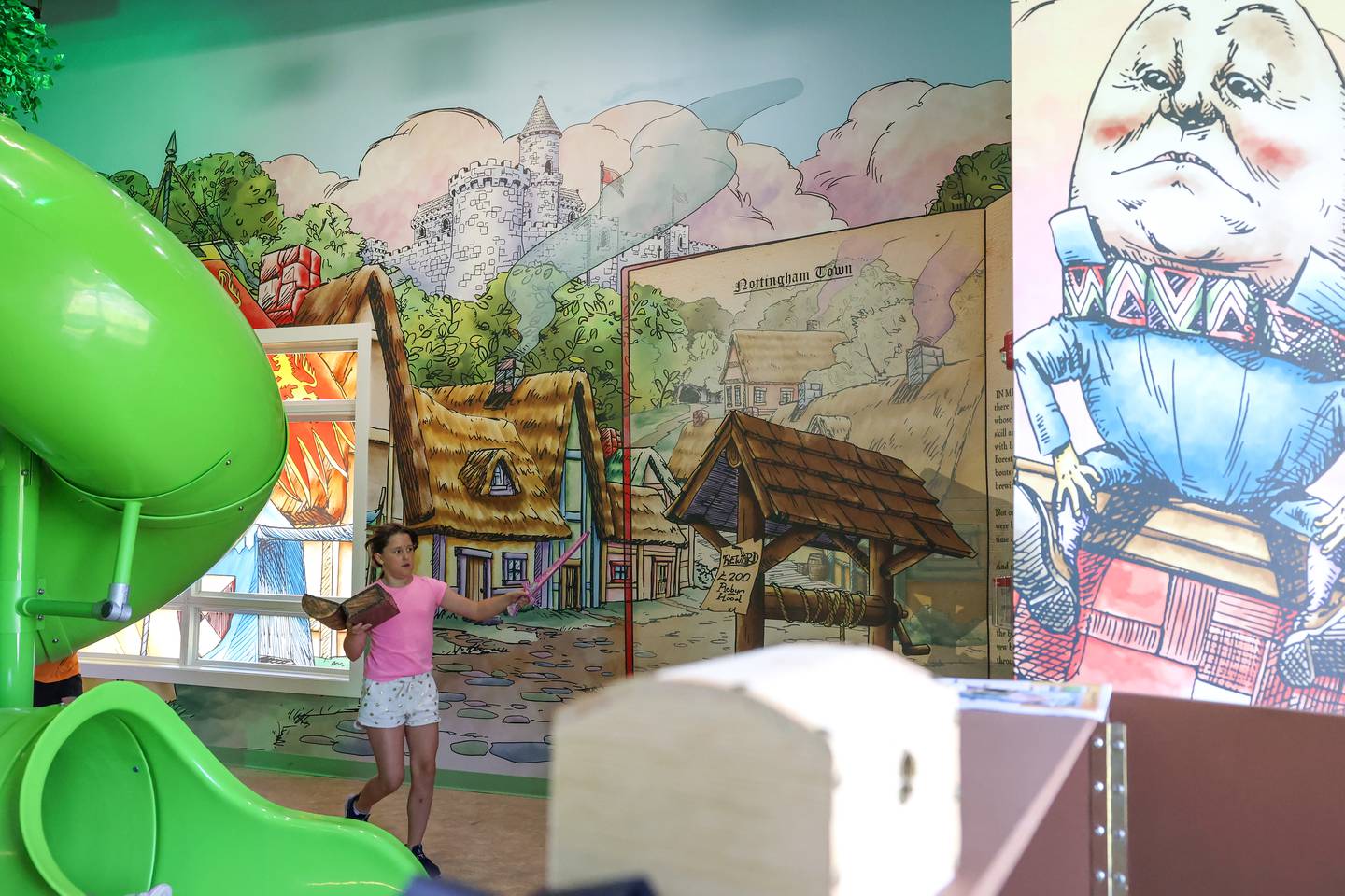 Themes from the pages of children's books decorate the walls of the Exploration Station's new Storybook Forest exhibit on Monday, June 23, 2025, during its grand opening event.