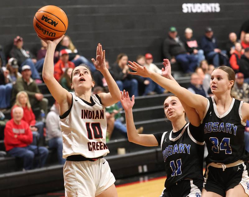 Indian Creek's Ally Keilman gets a layup in front of two Rosary defenders Tuesday, Feb. 10, 2026, during their game at Indian Creek High School in Shabbona.