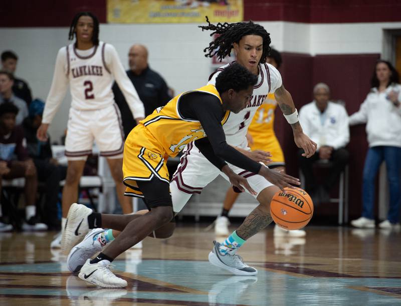Kankakee's Lincoln Williams, back, guards Richards's Reginald Johnson in the Kankakee Holiday Tournament at Kankakee High School on Saturday, December 27, 2025.