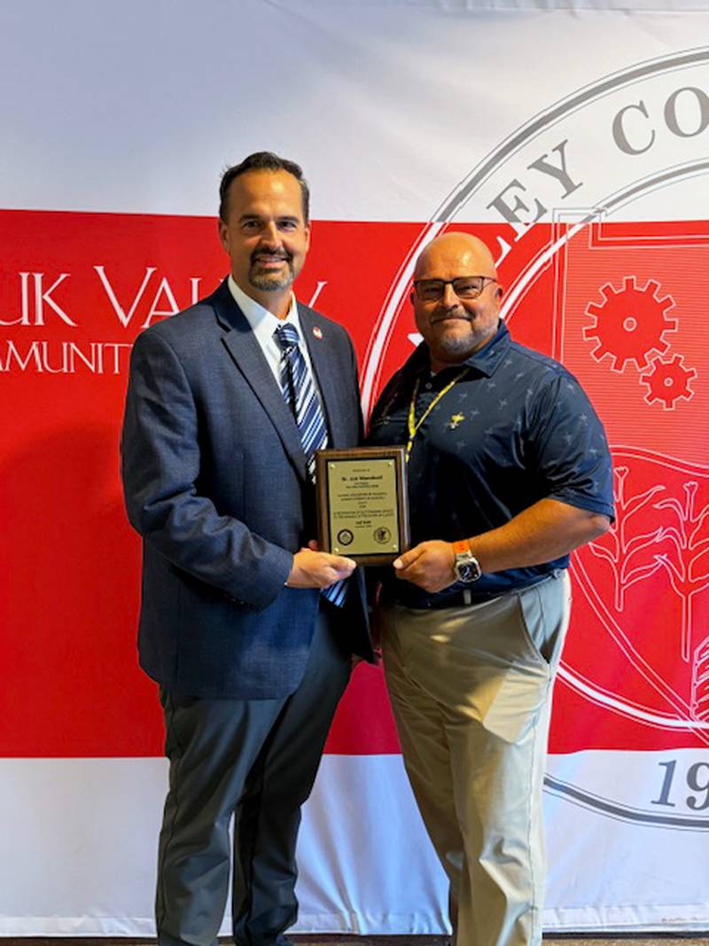 Regional Superintendent of Schools for ROE #47, Christopher Tennyson, presents Dr. Jon Mandrell with the Friends of Education Award.