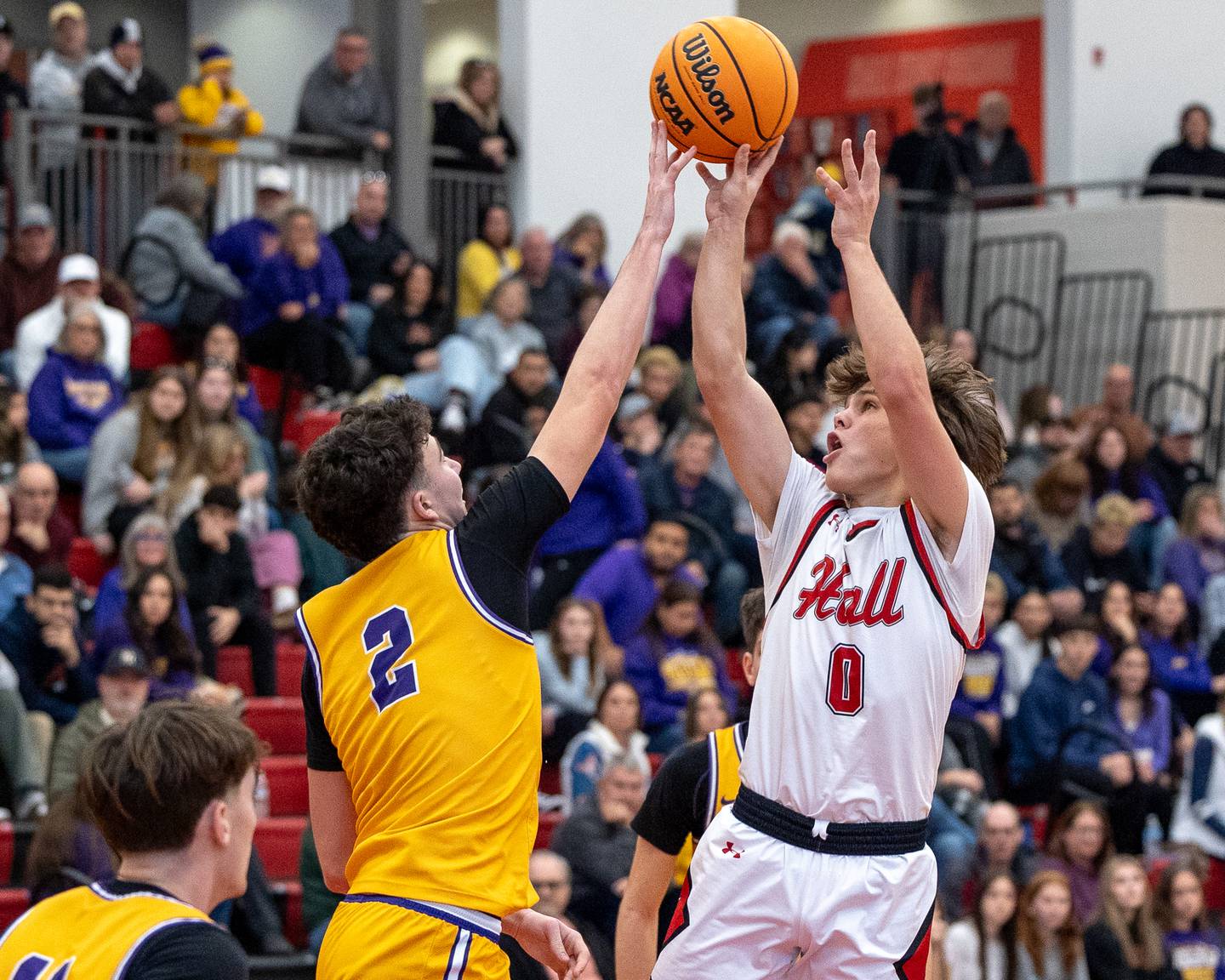Greyson Bickett (0) of Hall pulls up for midrange shot as Drew Becker (2) of Mendota blocks shot on Saturday, December 20, 2025 at Hall High School in Spring Valley.