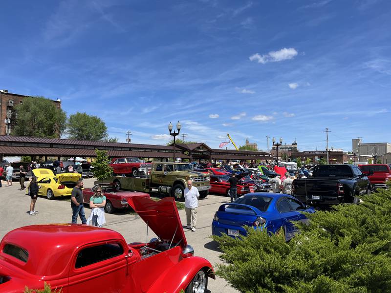 Community members walking around the Sterling Marketplace on Sunday, May 5, to marvel at the vehicles on display at Sterling's 11th annual car show.