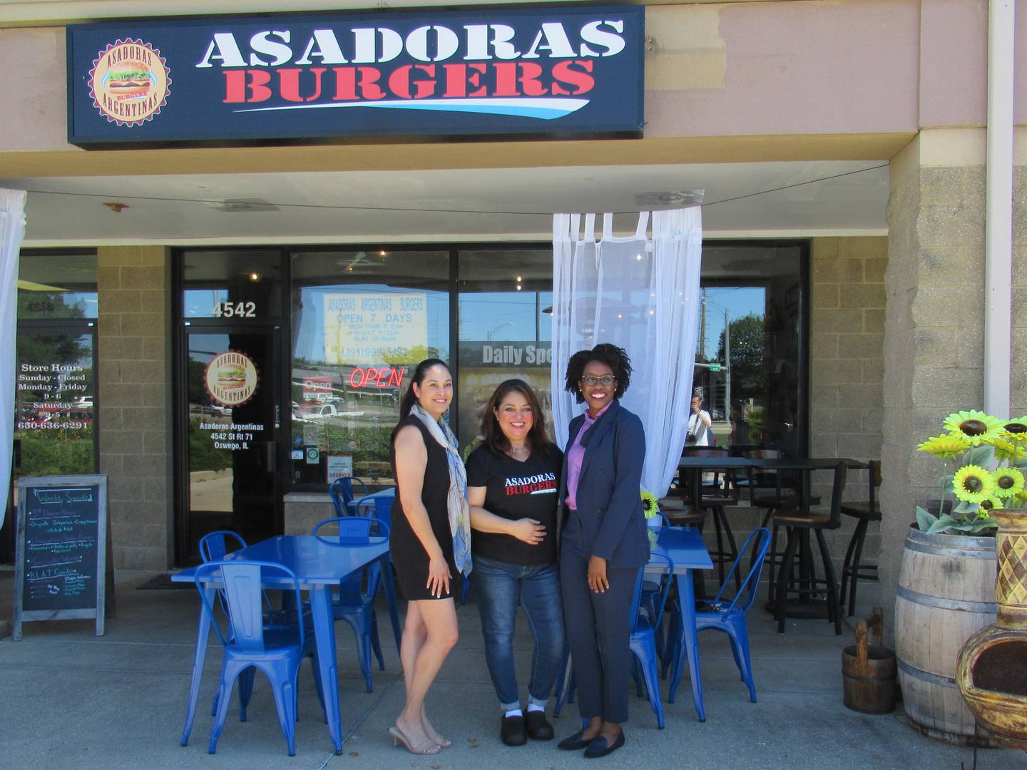 Part owner of Asadoras Argentina Burgers, Erica Caballos with Congresswoman Lauren Underwood and Marisa Alcantar, during a latinx small business tour Thursday, Aug. 11 2022, at 4542 IL-71 in Oswego. (from left to right: Alcantar, Caballos, Underwood)