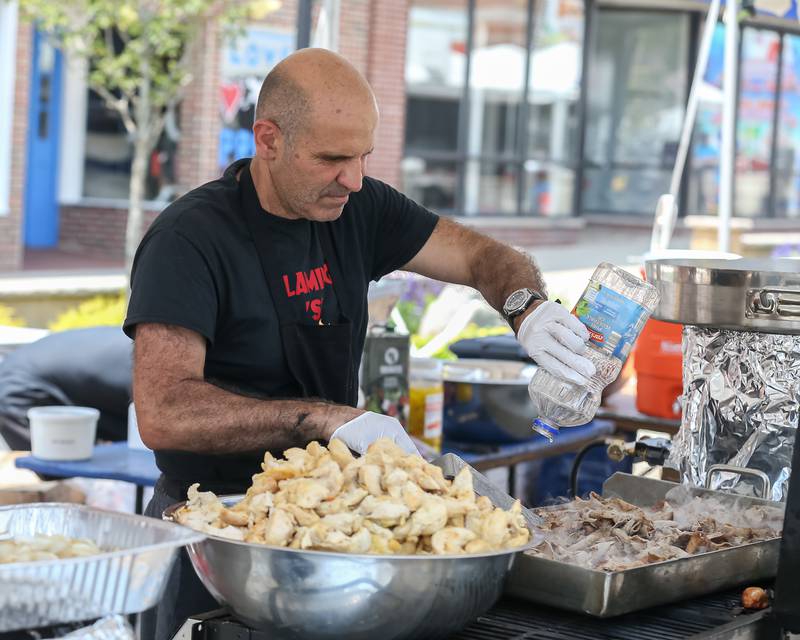 A vendor prepares food at the Downers Grove Rotary GroveFest in downtown Downers Grove. June 24, 2023.