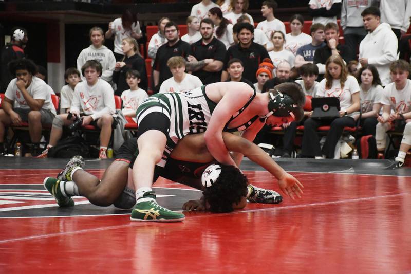 Bishop McNamara's Blake Arseneau, top, has top positioning on Bradley-Bourbonnais' Razi Perez during the All-City wrestling meet on Wednesday, Dec. 3, 2025.