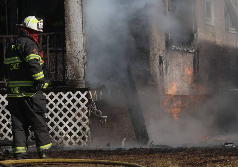 Peru Fire Chief Jeff King, stares at flames coming from a gas line while on the scene of a structure fire in the 800 block of Bucklin Street on Friday, Jan. 23, 2026 in La Salle.