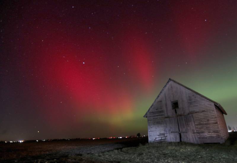 The Aurora Borealis (Northern Lights) dazzles over a barn near the intersection of Illinois Route 251 and 34th Road between Peru and Mendota on Tuesday, Nov. 11, 2025. Two coronal mass ejections (CMEs) created sparking geomagnetic storm conditions, according to the National Oceanic and Atmospheric Administration (NOAA). Space weather forecasters anticipate that geomagnetic activity may intensify to strong (G3) conditions overnight and could be around again tomorrow night.