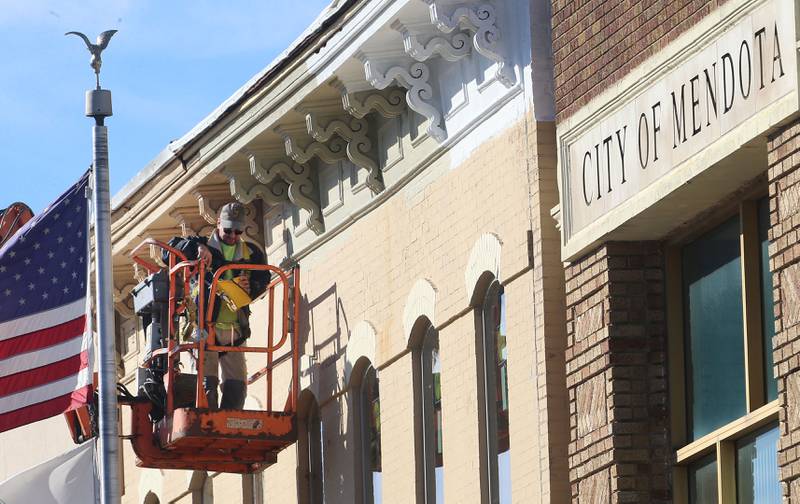 Dan Znaniecki of H&H Builders, applies a fresh coat of paint on the exterior of the Mendota Chamber of Commerce building on Monday, Oct. 27, 2025 downtown Mendota.
