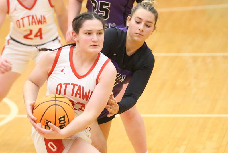 Ottawa's Mary Stisser pulls the ball away from Dixon's Reese Dambman on Wednesday, Dec. 3, 2025 in Kingman Gymnasium at Ottawa High School.
