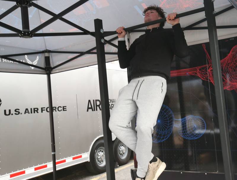 Vance Hayes, a student of DePue High School and La Salle-Peru Township High School Area Career Center, does a set of pull-ups during “Own The Sky,” a USAF Virtual Airborne Experience on Wednesday, March 19, 2025 in the Dolan Building parking lot at L-P High School. The mobile unit allowed students to put them in virtual reality Air Force flight simulators and pull-up challenge. The U.S. Air Force is the most advanced, most powerful air force in the world. The mobile tour is divided up into two unique VR experiences, students had the option to pilot an F-35 fighter through a canyon using a real-life throttle and flight stick or operate a replica KC-135 boom pod to refuel several airborne aircraft including a B-2 Stealth Bomber. The simulator was brought to La Salle-Peru Township High School with the help of the U.S. Air Force recruitment office inside the Peru Mall.