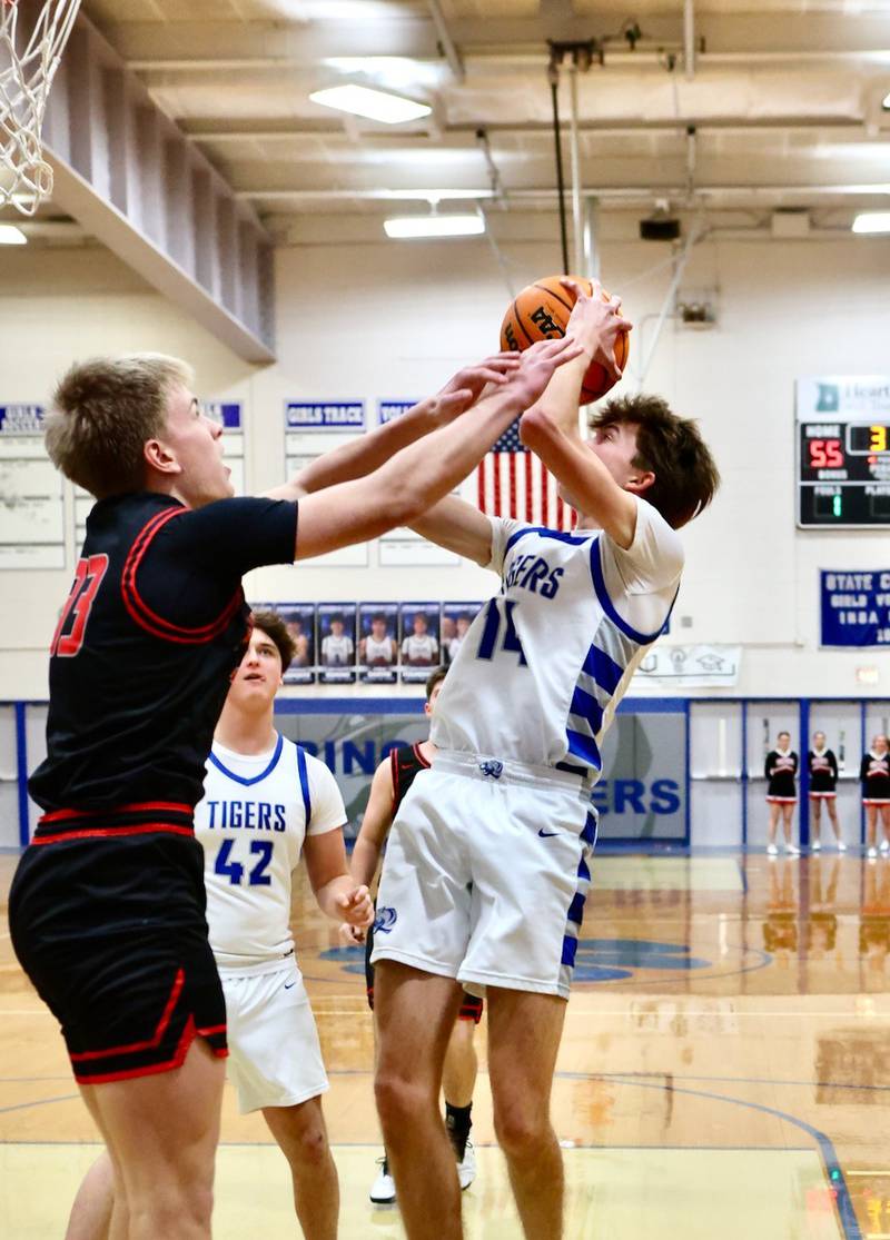 Princeton junior Jackson Mason gets a helping hand from Erie-Prophetstown's Sawyer Copeland Friday night at Prouty Gym.