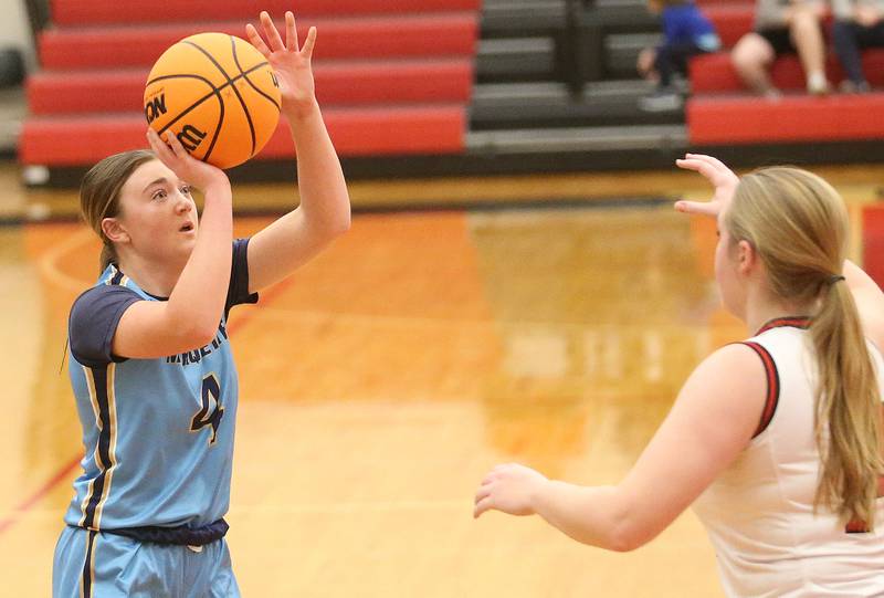 Marquette's Hunter Hopkins lets go of a jump shot over Hal's Jacalynn Qasem on Thursday, Feb. 13, 2025 at Hall High School.