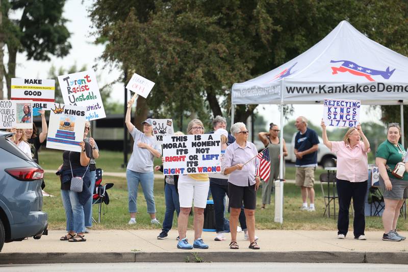 Protesters hold signs along East Court Street during a "Good Trouble Lives On" rally held in Kankakee as part of a national day of peaceful protests on Thursday, July 17, 2025.