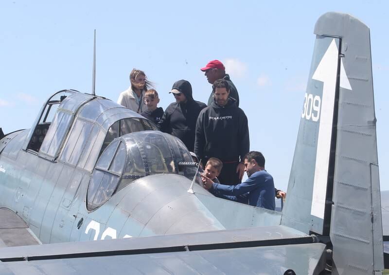 Spectators check out the inside of a TBM aircraft during the 10th annual TBM Avenger Reunion and Airshow on Saturday, May 17, 2025 at the Illinois Valley Regional Airport in Peru.