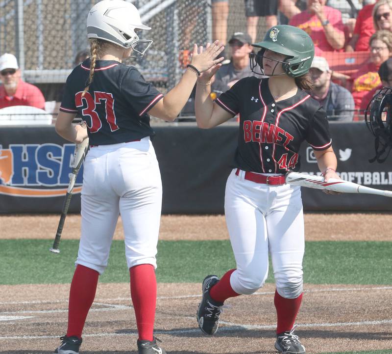 Benet Academy's Gianna Horejs hi-fives teammate Angela Horejs after scoring a run against Charleston during the Class 3A State third place game on Saturday, June 10, 2023 at the Louisville Slugger Sports Complex in Peoria.
