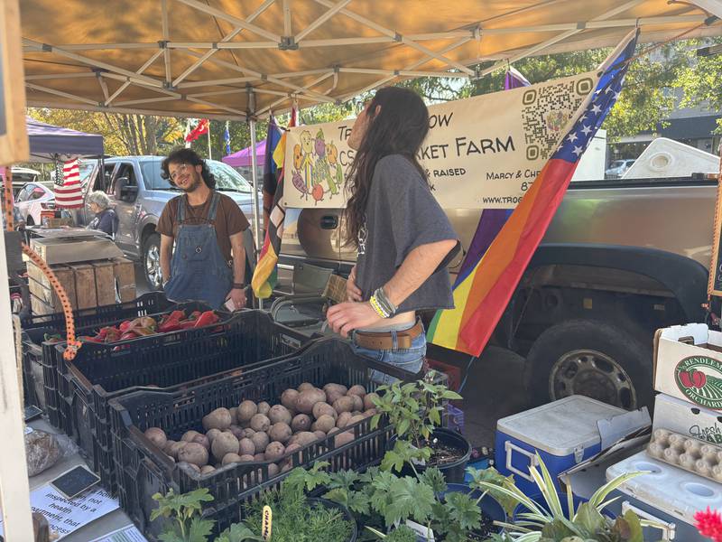 Oliver Myers, left and Orin Prchal talk at the Huntley Farmers Market Oct. 4, 2025.