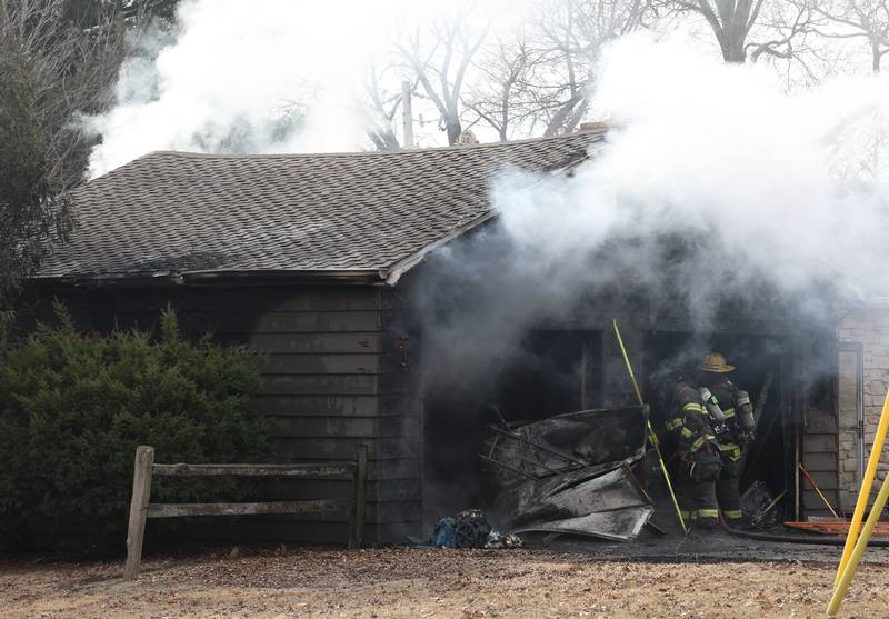 Firefighters work the scene of a garage fire in the 1900 block of Shooting Park Road on Monday, Feb. 9, 2026 in Peru. La Salle, Peru, Utica, Oglesby and Spring Valley fire departments were dispatched around 12:15p.m. to the fire.