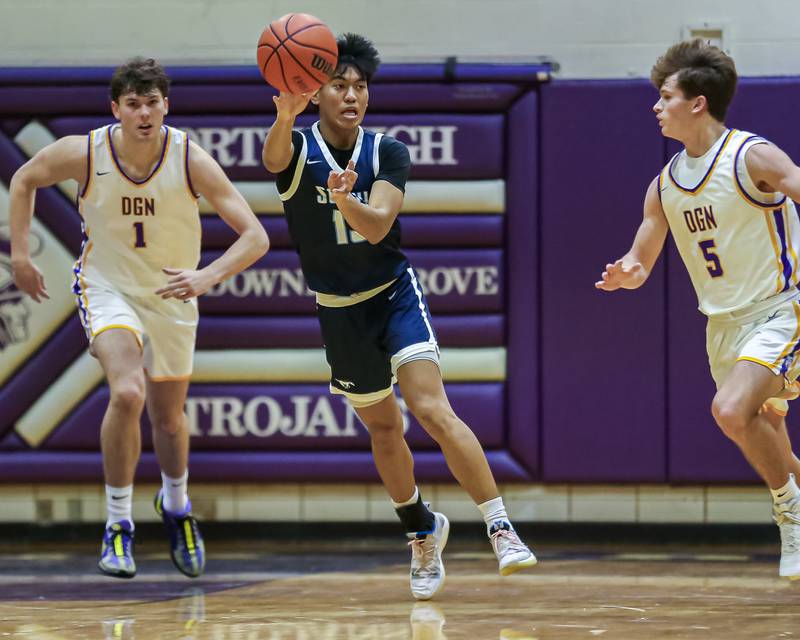 Downers Grove South's Richard Gasmen (13) unleashes a out let pass during basketball game between Downers Grove South at Downers Grove North. Dec 16, 2023.