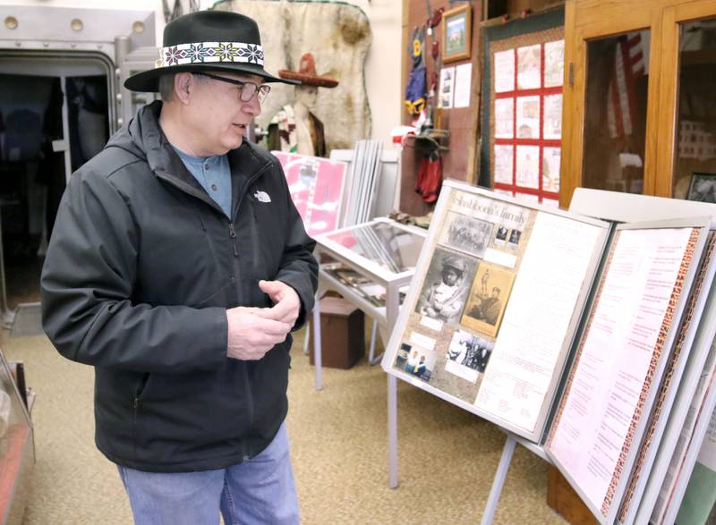 Prairie Band Potawatomi Nation Chairman Joseph Rupnick (left) looks at photos and literature related to Native American history in the area, including photos of his family, Friday, Dec. 17, 2021, at the Shabbona-Lee-Rollo Historical Museum in Shabbona.