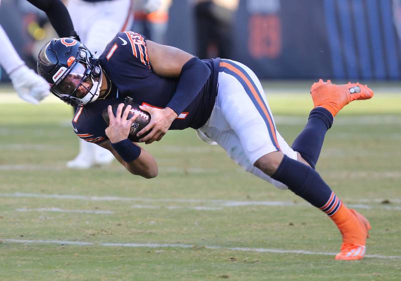 Chicago Bears quarterback Justin Fields dives for extra yardage in front of Philadelphia Eagles linebacker Kyzir White during their game Sunday, Dec. 18, 2022, at Soldier Field in Chicago.