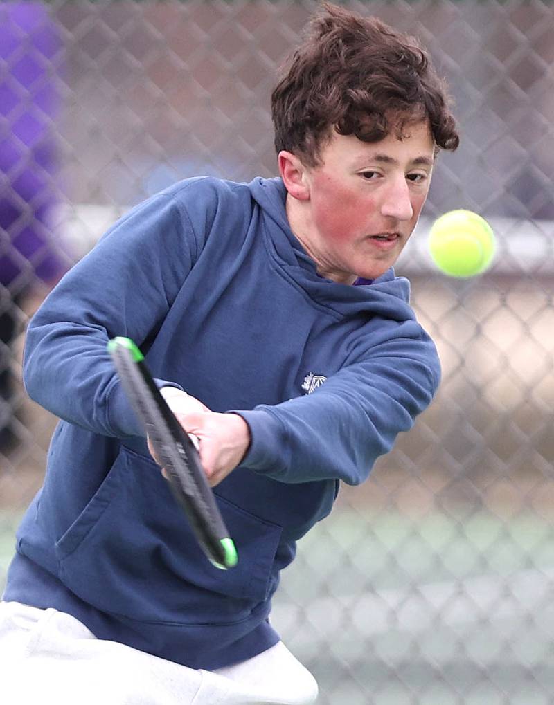 Dixon’s number one singles player Bashar Elbzour follows through on a backhand during his match against Sycamore Thursday, March 30, 2023, at Sycamore High School.