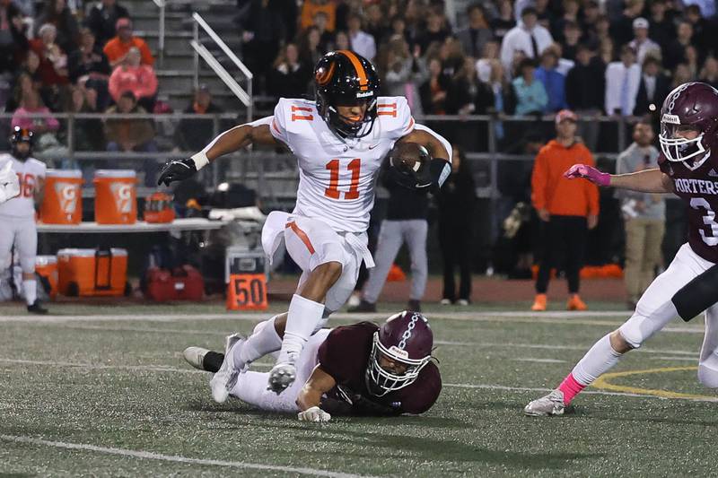 Lincoln-Way West’s Austin Rowswell avoids the tackle after a catch against Lockport on Friday, Oct. 18, 2024 in Lockport.
