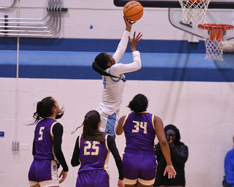 Downers Grove South's Hayven Harden (4) makes a basket during the game while taking on Downers Grove North on Saturday Dec. 21, 2024, held at Downers Grove South High School.
