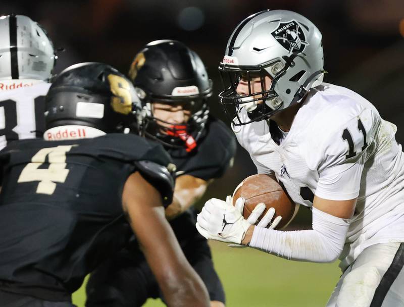 Kaneland's Dominick DeBlasio tries to split two Sycamore defenders during their game Friday, Sept. 29, 2023, at Sycamore High School.