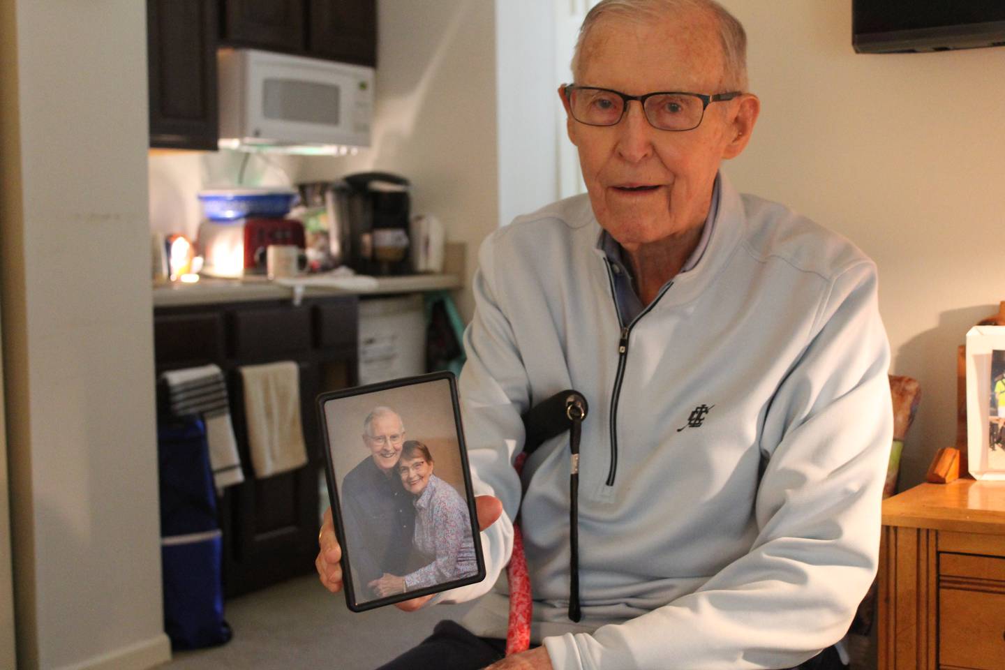 Bob Blazier, 97, holds a picture of him and his wife Rosemary Blazier. The couple celebrates 75 years of marriage Tuesday.
