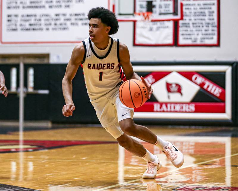 Bolingbrook's Braden Pettigrew (1) makes a move to the basket during their basketball game between Plainfield North at Bolingbrook, Friday Dec 13, 2024 in Bolingbrook.