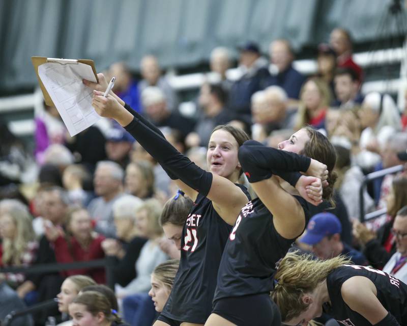 The Benet bench celebrates a point during Class 4A Glenbard West Sectional final volleyball match between St Charles North at Benet. Nov 6, 2025 in Glen Ellyn.