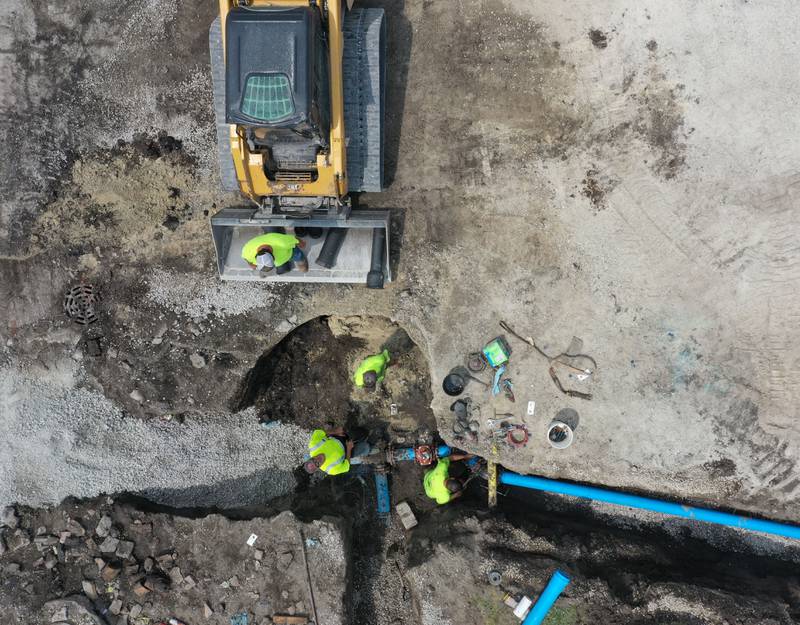 Crews continue to work on the site of the Utica retail plaza near the intersection of Mill and Grove streets on Wednesday, July 24, 2024 in Utica. Workers have begin replacing water lines, adding rock and preparing to redo the the Market on Mill area. The project is scheduled to be completed just before Burgoo.