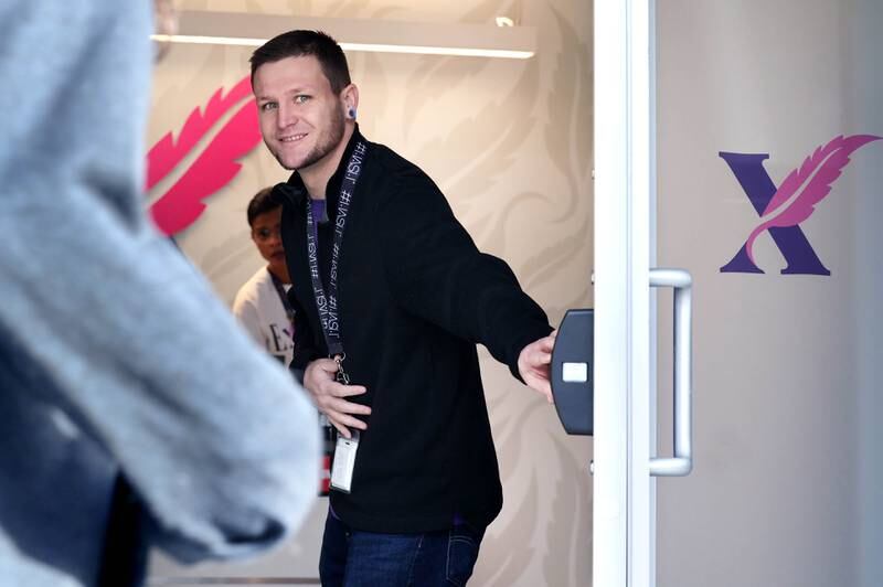 Joe Mason, a budtender at Excelleaf, opens the store for the first time ever Friday, Nov. 24, 2023, during the soft opening of the dispensary in DeKalb. The business is DeKalb County’s first recreational marijuana dispensary.