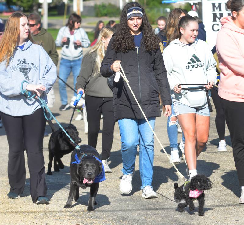 Nova, a poodle mix, didn't let 3 legs slow her down at the Polo High School’s 2025 Doggy Dash as she heads out on the 1-mile walk with Maci Mandrell (center) on Saturday, Sept. 6, 2025.