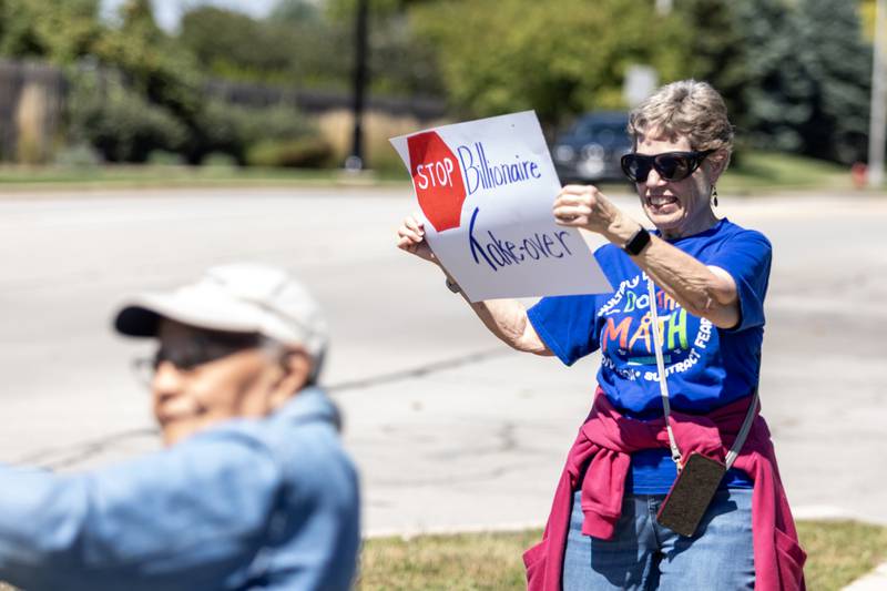 Dorothy Brumbaugh holds-up a sign during the ‘Workers Over Billionaires’ Labor Day Protest on the 1100 block of N. River Rd. in Shorewood, IL, on Sept. 1, 2025.