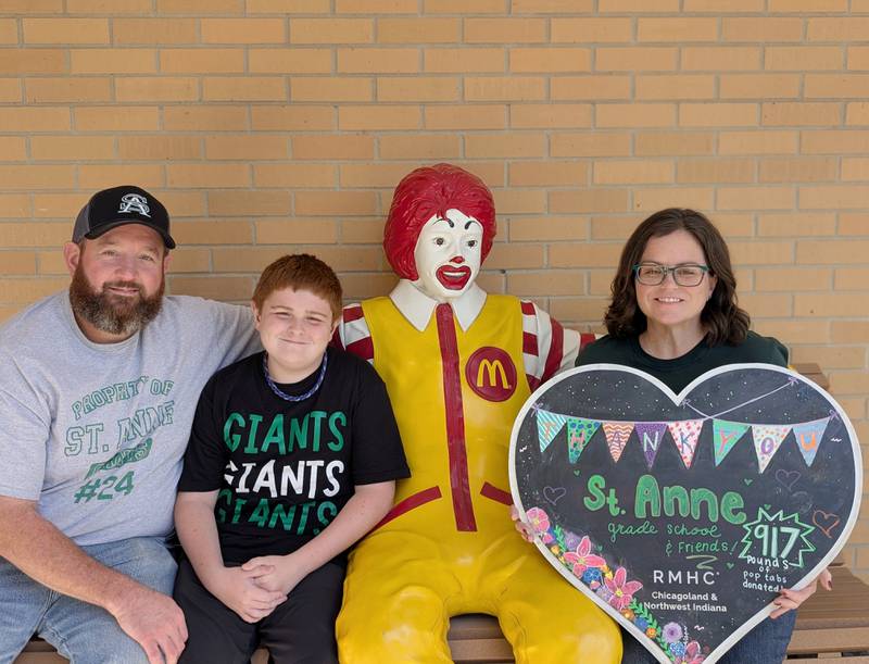 Ashley Childress, right, her son Jesse, 12, and husband, Mike, pose for a photo at the Ronald McDonald House Chicago after donating 917 pounds of pop tabs, equivalent to 1 million tabs, on behalf of St. Anne Grade School in August.