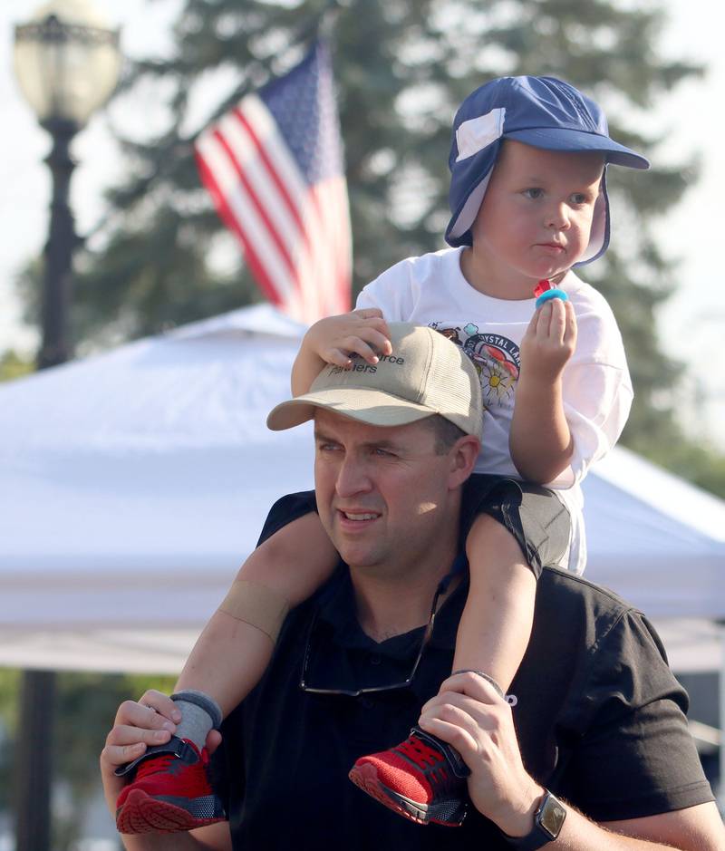 Sean Dooley of Crystal Lake strolls with his son Declan, 3, during National Night Out activities in downtown Crystal Lake on Thursday, Aug. 7, 2025.