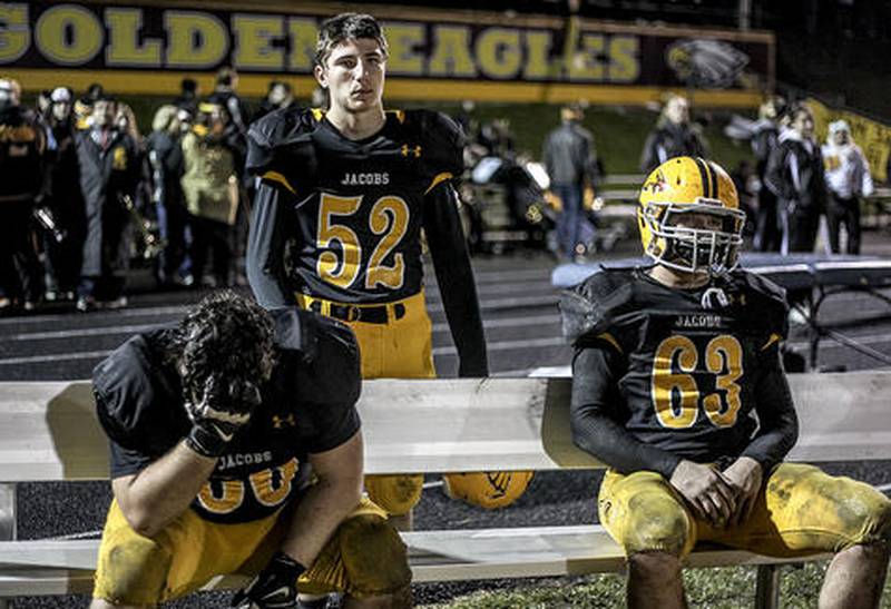 Jacobs' Jonny Cieniewicz (left), Sam Leonard and Carson Shoemaker watch the last minutes of Friday's playoff game against Conant in Algonquin November 1, 2013. Conant defeated Jacobs, 42-35.