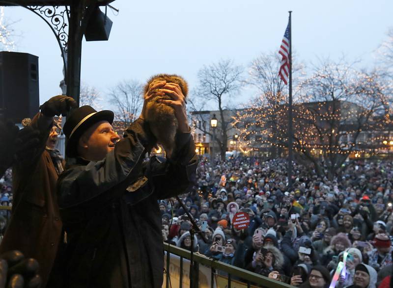 Woodstock Willie is held by handler Mark Szafran as Stephen Tobolowsky who played "Ned Ryerson" in the movie "Groundhog Day" announce that there will be an early spring on Sunday, Feb. 2, 2025, during the annual Groundhog Day Prognostication in the Woodstock Square.