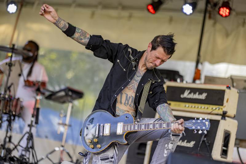 Abbynormal guitarist Craig Peek entertains the crowd Sunday, May 26, 2024, with roundhouse strums of the guitar at the Music and Arts Festival at Pulaski Park in La Salle.