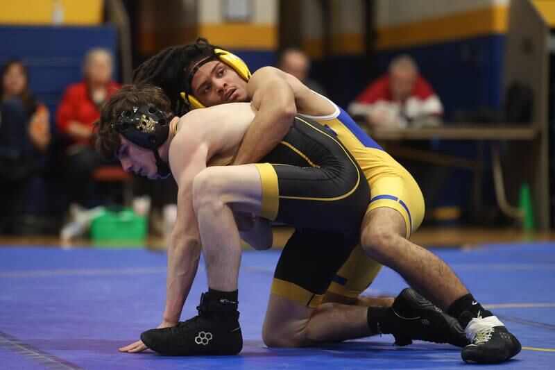 Joliet Central’s Jowel Maldonado wraps up Joliet West’s Joseph Jaburek in the 126-pound weight match at Joliet Central on Friday, Jan 31, 2025.