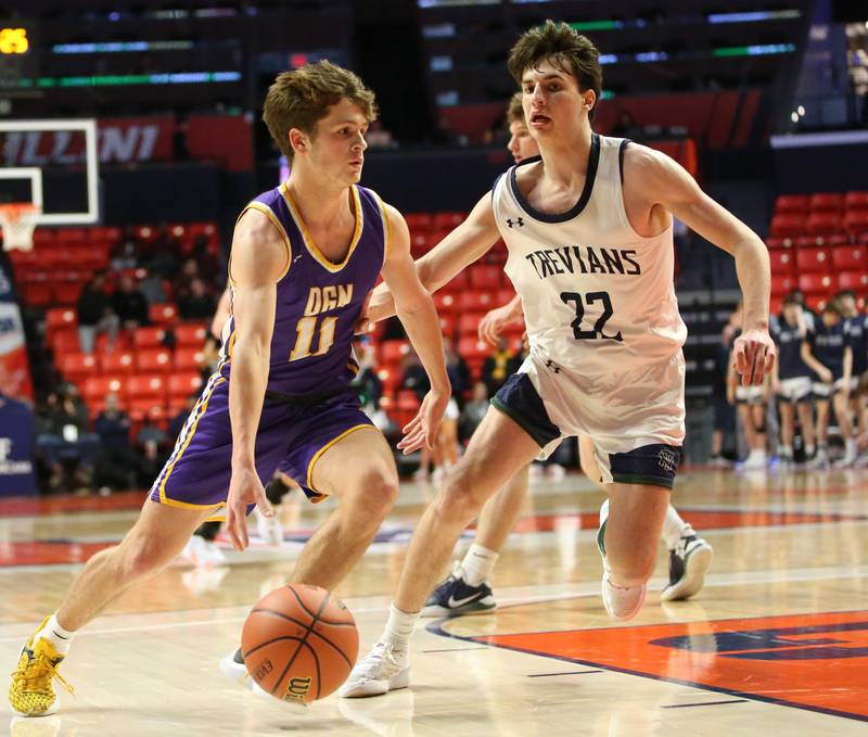 Downers Grove North's Owen Thulin dribbles past New Trier's Logan Feller in the Class 4A state third place game on Friday, March 10, 2023 at the State Farm Center in Champaign.