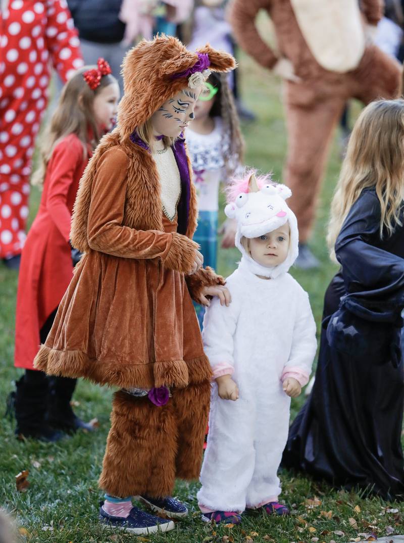 Abby, 9, and Anneliese W., 2, of Downers Grove dance during the Monster Mash Dance Party at Fishel Park in Downers Grove, Ill. on Saturday, October 29, 2022.