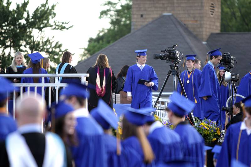 Lyons Township High School graduates walk across the stage during the school’s 2023 commencement ceremony in Western Springs on Wednesday, May 31, 2023.