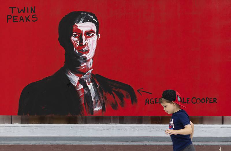 A youngster passes by the Lynchian work of an unknown artist during Morrison’s Paint the Town event Saturday, Sept. 20, 2025.