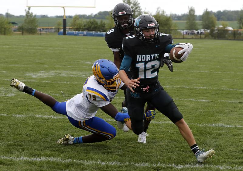 Woodstock North's Landan Creighton scores a touchdown as Johnsburg's Chiamaka Ameachi tries to tackle him during a Kishwaukee River Conference football game Saturday, Aug. 26, 2023, at Woodstock North High School.