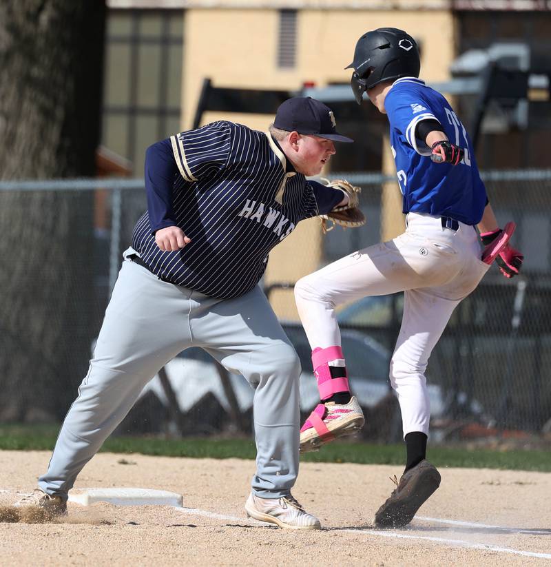 Hiawatha’s Logan Brush has to tag Hinckley-Big Rock's Skyler Janeski after the throw pulled him off the base Tuesday, April 29, 2025, during their game at Hiawatha High School in Kirkland.