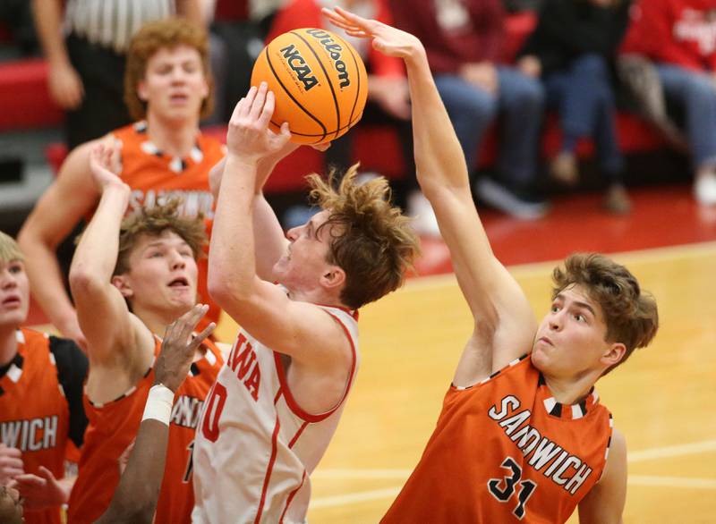 Ottawa's Evan Snook eyes the hoop as Sandwich's EJ Treptow looks to block it his shot on Wednesday, Dec. 4, 2024 in Kingman Gym at Ottawa High School.
