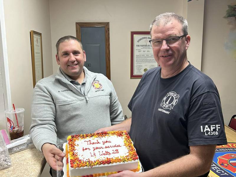 A cake is presented to Fire Lt. Joe Welte for his 33 years of service to the Princeton Fire Department.